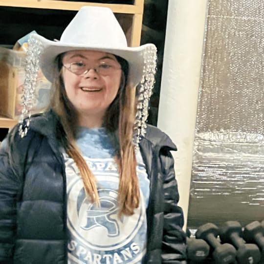 photo of Penny smiling at the camera and wearing a cowboy hat