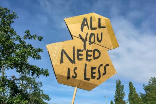Image: A roughly-fashioned cardboard sign on which is written in black magic-marker 