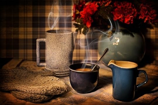 Gray vase with red roses, gray coffee pot, blue ceramic cup with spoon, blue ceramic pitcher, gray mittens, against black and white plaid background.