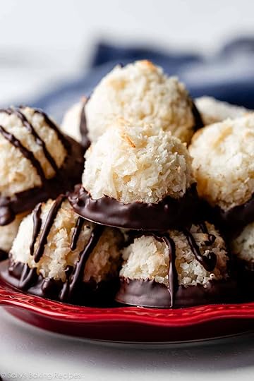 red plate with chocolate dipped coconut macaroons.