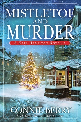 Cover art for Mistletoe and Murder, by Connie Berry. Winter village scene with snow and a lit Christmas tree.