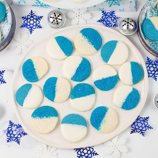 Blue and white Christmas Cookies on a glass plate.