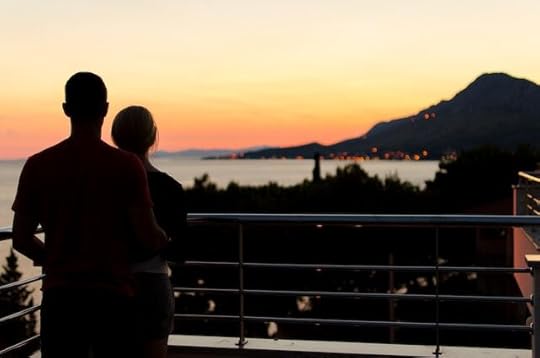 Digital nomad couple staring at sunset on a Philippines island