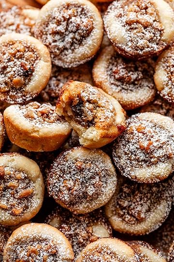 close-up of maple walnut tassies with one with bite taken out.