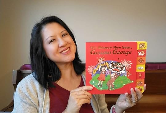 Maria with her new book, IT'S CHINESE NEW YEAR, CURIOUS GEORGE! Photo Credit © Maria Wen Adcock
