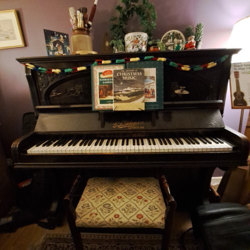 piano with books of Christmas carols on the music stand