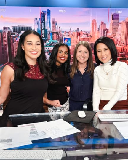 photo of NBC news hosts and Niro Feliciano and Amy Julia Becker smiling for the camera behind a glass desk at NBC studios