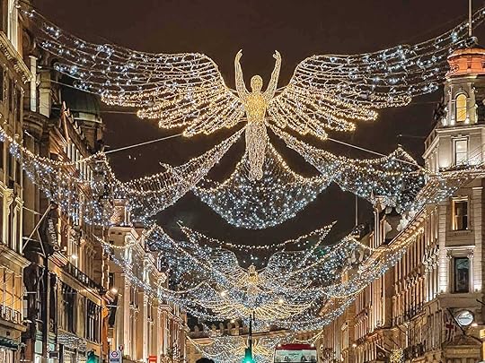 A street with lights and angelsDescription automatically generated