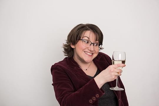 Elizabeth holding a glass of wine