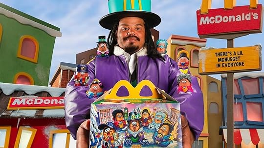Kerwin Frost in costume holding an Adult Happy Meal with McNugget Buddies on his arms