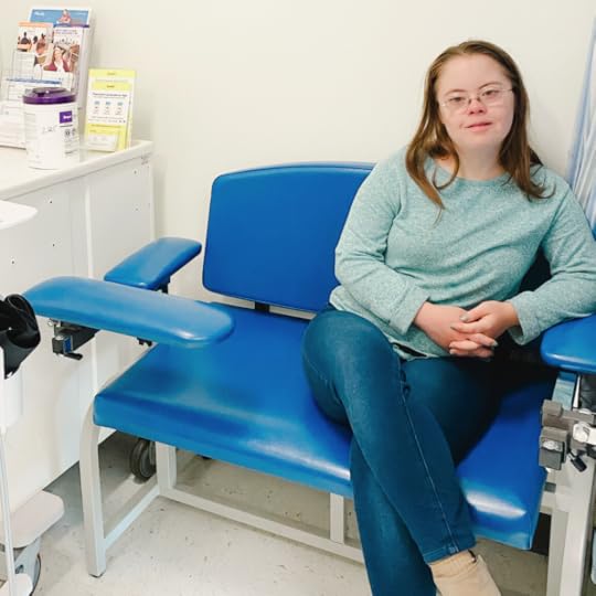 photo of Penny sitting in an exam room for Mass General Down syndrome clinic