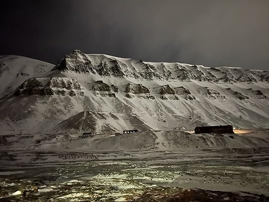 a snowy mountain with a building in the distance