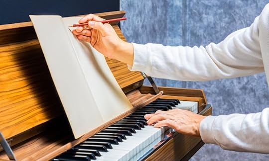 songwriter playing keys on a piano and writing down notes on paper; Permissions for My Book