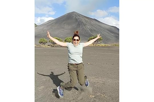 Lisa Niver jumping in front of a volcano in Vanuatu