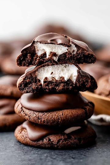 stack of hot cocoa cookies with top two broken open to reveal marshmallow inside.