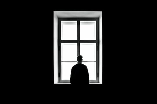 man in front of a window
