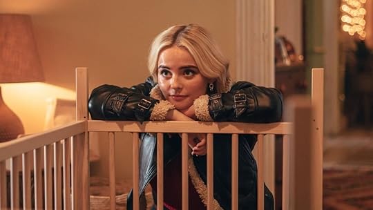 millie gibson as ruby sunday leans over a baby crib railing in doctor who christmas special