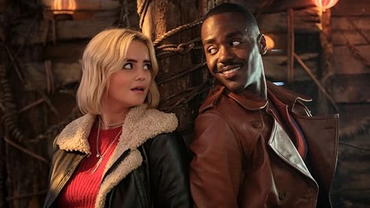 Ncuti Gatwa and Millie Gibson sit beside each other tied to a pole in doctor who christmas special episode