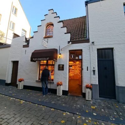Photo of chocolate shop in Bruges on cobbled street