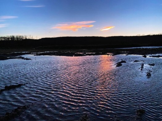 Nacreous clouds over water