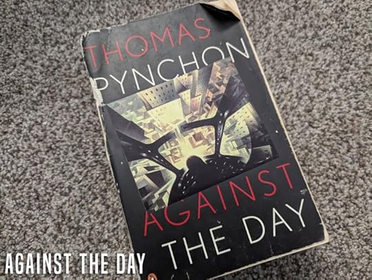 Copy of Thomas Pynchon's Against the Day on a carpet.