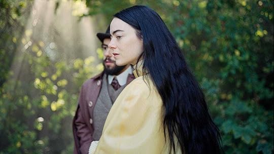 Emma Stone with long black hair, slightly obscuring Ramy Youssef, in 