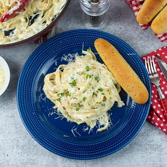 Olive Garden Alfredo Sauce served over fettuccine with garlic sticks.