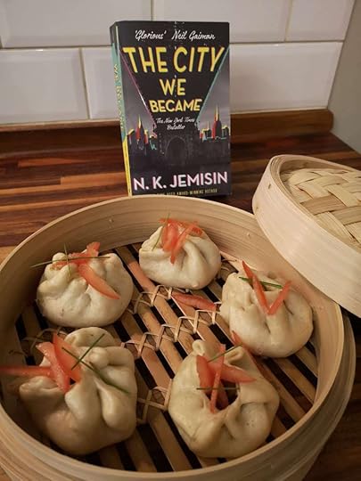 A ridiculously beautiful steamer full of dumplings in front of N.K. Jemisin's 