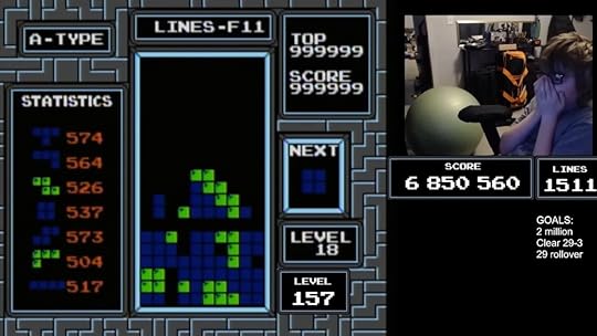 A Tetris screen frozen with an inlay of a kid holding his face in excitement