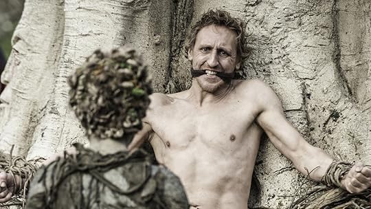 A child of the Forest gets ready to stab a man chained to a tree on Game of Thrones