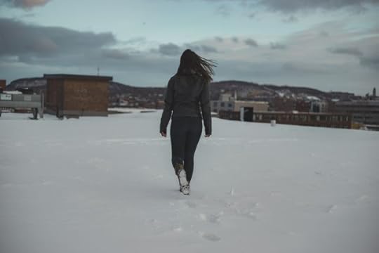 woman walking a snowy path to choose.