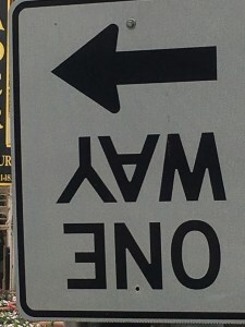 upside down one way sign