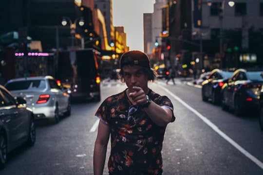 You are worthwhile and deserving of experiencing this life. Guy pontng to the camera on a street