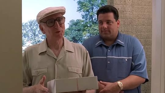 Uncle Junior in his white capo holding pastries with Bobby Bacala in the doorway next to him on The Sopranos
