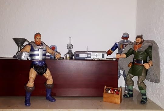 Duncan and Roboto are tinkering with a very big gun, while Malcolm leans against the counter