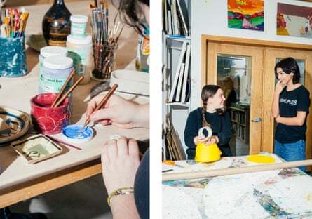 A student decorates a piece during a ceramics class, while other students interact during an art block at Buxton school.