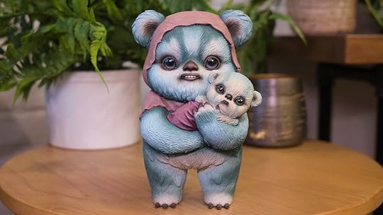 Sideshow's Ewok statue holding a baby standing on a table
