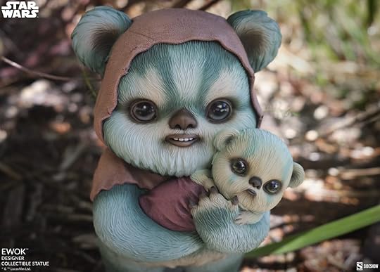Close up of Ewok holding a baby statue