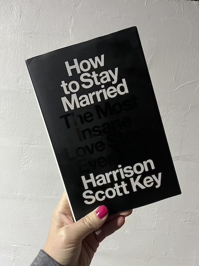 hand holding the book How to Stay Married