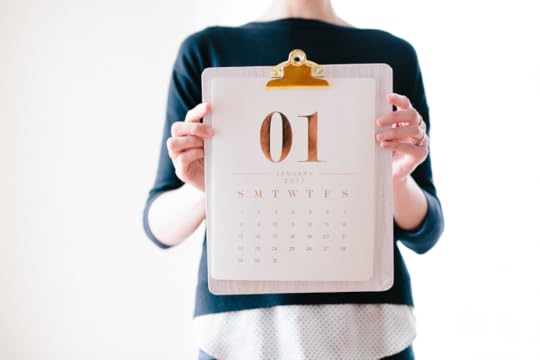 woman holding a clip board with a calendar page
