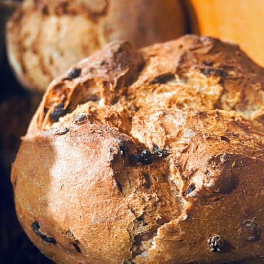 loaf of round brown bread with raisins