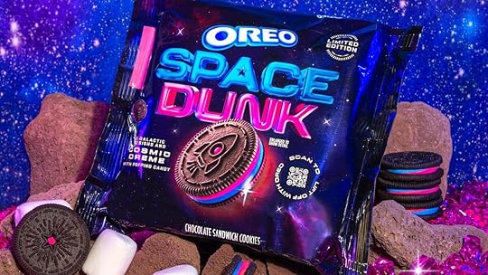 A package of Oreo Space Dunk cookies with a blue and pink color scheme atop rocks, cookies, and marshmallows