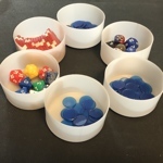 White plastic cups with dice and tokens