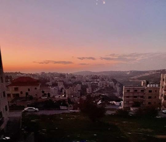 View from Ramallah hotel with a pink sky cascading over the city.