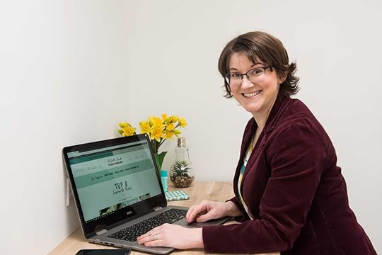 Elizabeth at desk with vase of daffodils