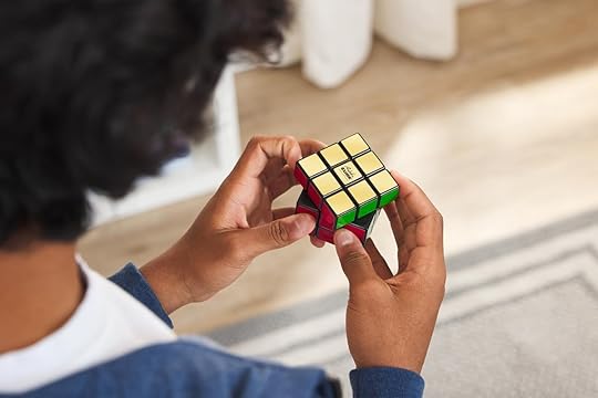 Adult tries to solved the Retro Rubik's Cube puzzle.