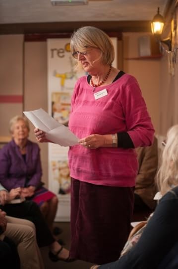 photo of Clare giving a reading to an audience