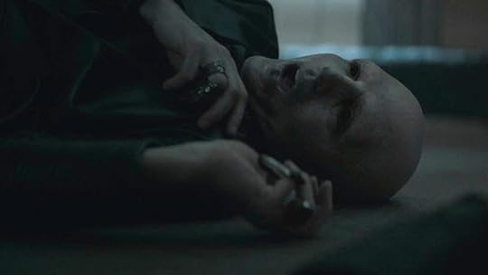 A bald man lies dead with his arms near heis neck in in Dune