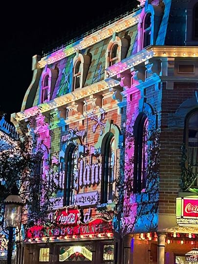 Images for the 5K runDisney race are projected on the front of a store on Main Street, U.S.A.