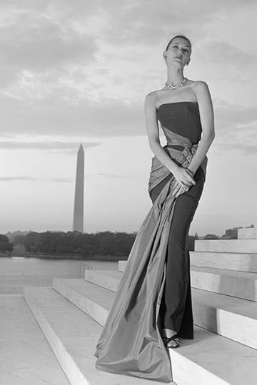 Fashion model posing in an evening gown on the steps of the Jefferson Memorial, with the Tidal Basin and Washington Monument in the background